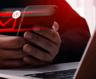 Closeup of a pair of hands that are holding a cellphone. A red envelope is hovering near the phone with a hazard sign, indicating that it's been flagged by Email Relay.