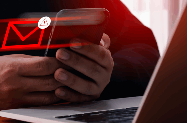 Closeup of a pair of hands that are holding a cellphone. A red envelope is hovering near the phone with a hazard sign, indicating that it's been flagged by Email Relay.