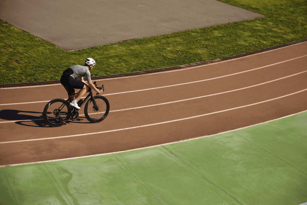A person on a bicycle is racing on a track.