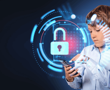 A young boy is concentrating on a cellphone. There is a hologram of a lock in front of him, representing VPN parental controls.