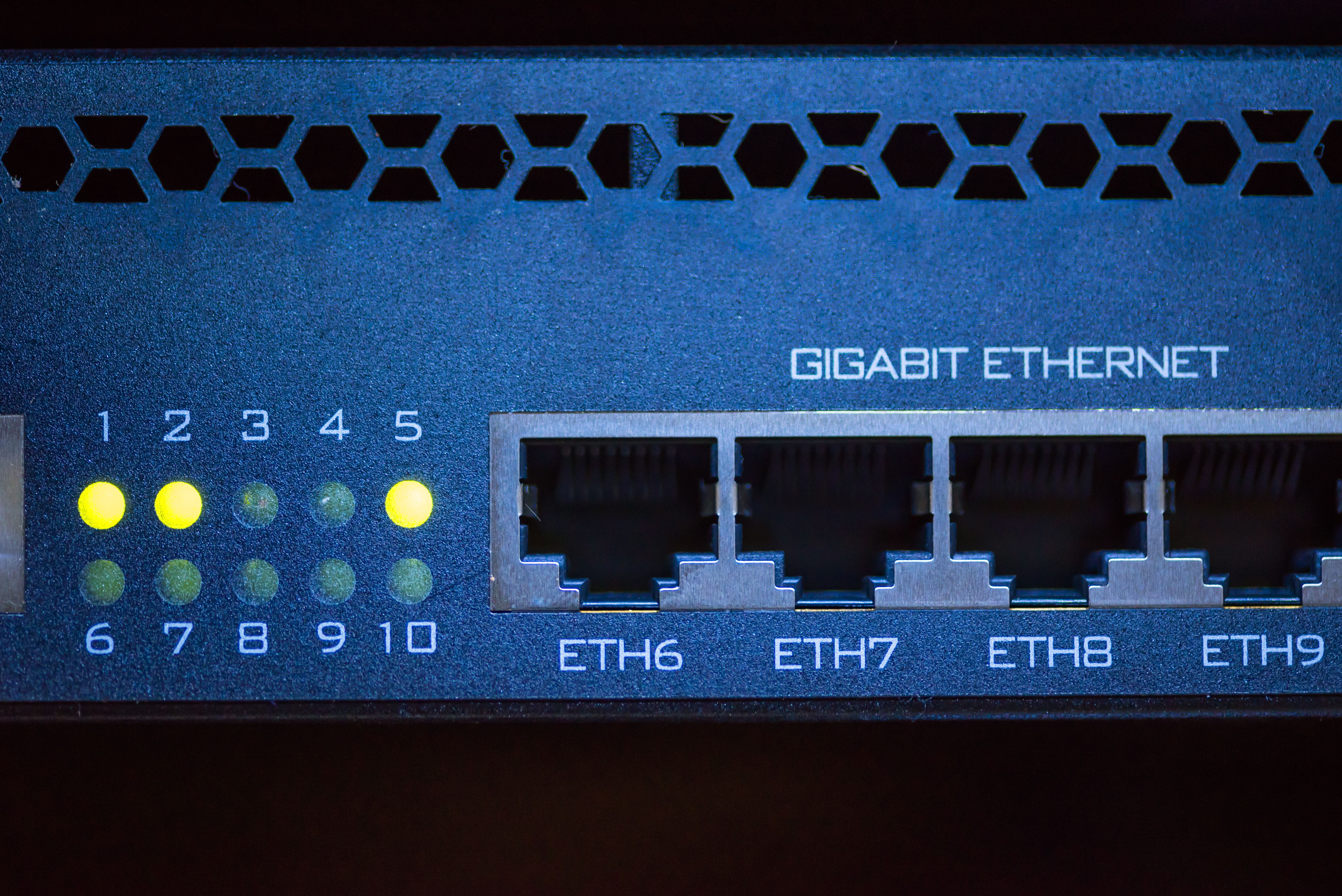 The back of a router with  ports for ethernet cables and lights indicating that ports 1,2, and 5 are being used.