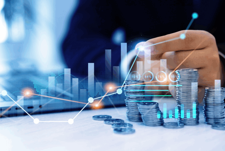 Stack of coins next to a laptop representing vpn pricing.