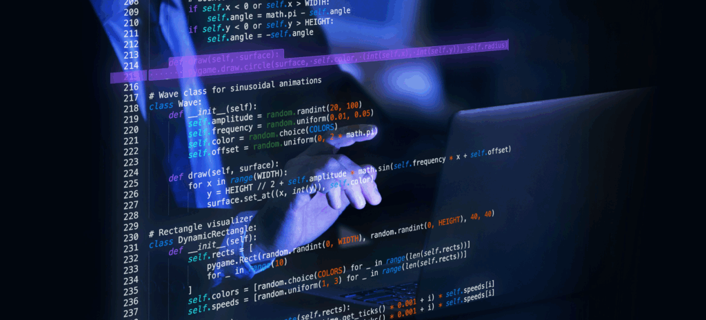 A person pointing to a leucite wall displaying computer code.