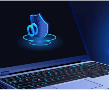 A laptop is sitting on a blue and black background. To the right is a shield reading "VPN" and to the left a shield with a lock on it, representing antivirus. We're trying to visually represent, "what is the difference between vpn and antivirus​", which is not easy, let me tell you.