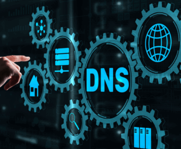 Hologram of several interlocking gears with a hand reaching out to touch them. The largest gear says, "DNS."