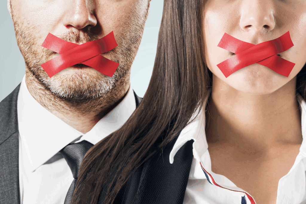 Two people, a man and a woman, with red tape over their mouths.
