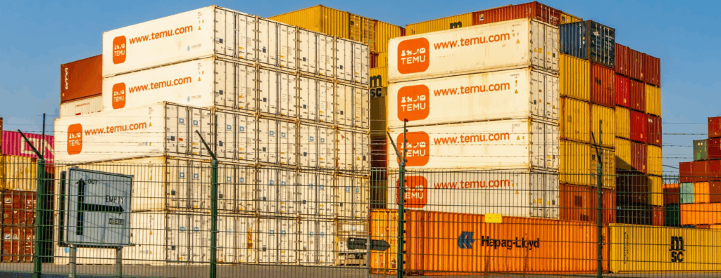 Several shipping containers with the Temu logo on them are stacked on a dock.