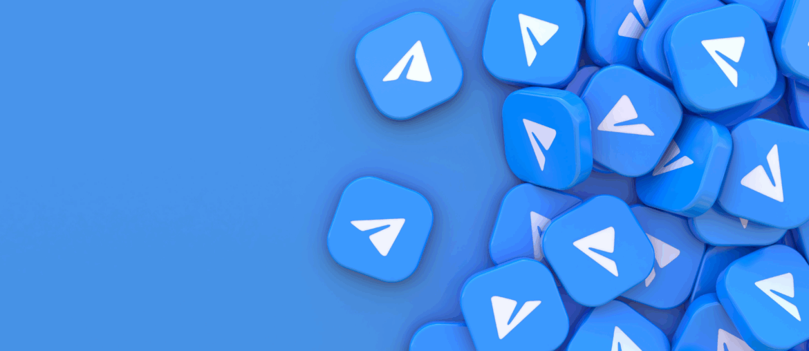 A pile of blue blocks with the Telegram logo on them is sitting on a blue background.