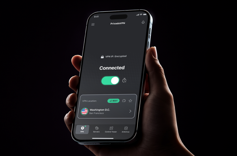 A closeup of a hand holding an iPhone with the PrivadoVPN app on the screen.
