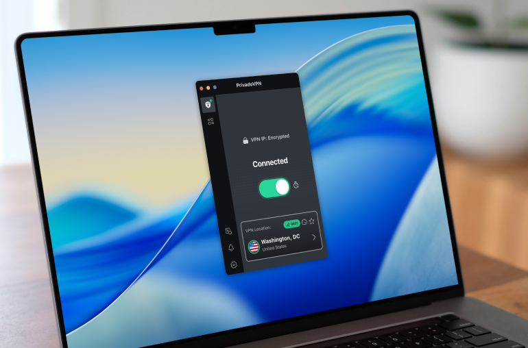 An Apple laptop sitting on a brightly-lit desk. The PrivadoVPN app for macOS is on the screen.
