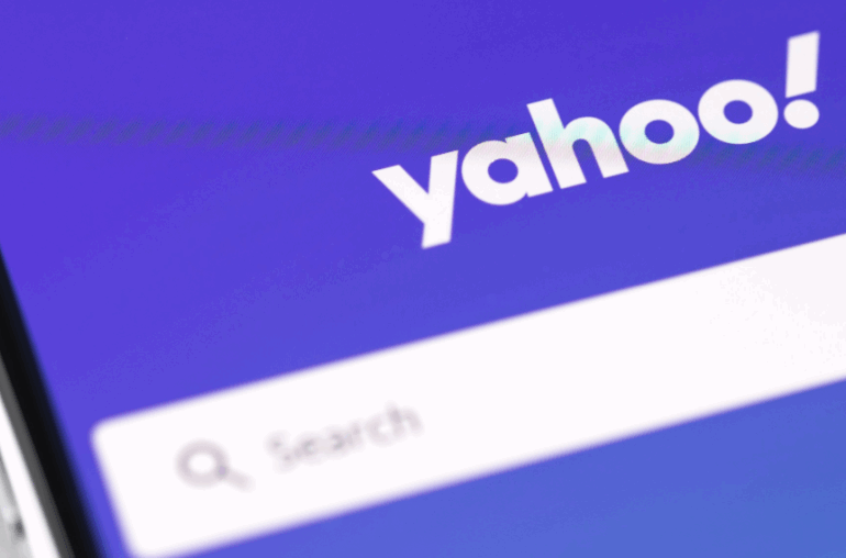 The Yahoo! search page in closeup. There is a search bar and the Yahoo logo on a purple background. The place to start if you want to know, "How can I delete yahoo mail account?"
